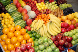 Freshly harvested collection of organic fruits as background. Close up of many colorful fruits on market stand. Big assortment of organic fruits on market