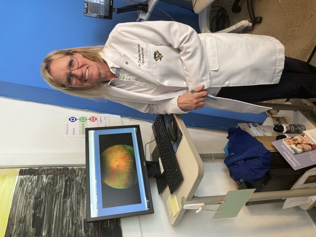 Dr Claudia Wendel stands in front of her Optomap machine.